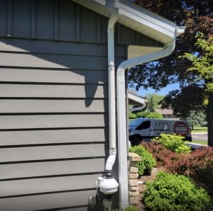 Exterior shot of a radon mitigation system, releasing radon gas safely away from the living spaces of a home"